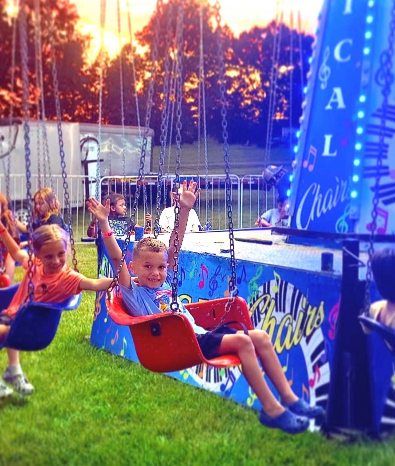 Families enjoying the midway at the Fayette County Fair
